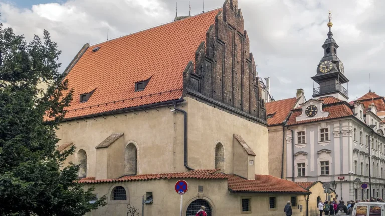 Staronová synagoga v pražském Josefově s cihlovým štítem, vpravo Židovská radnice s hodinami