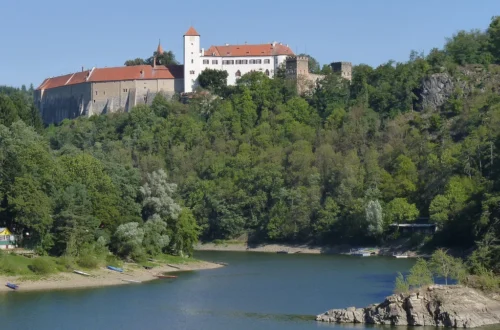 Hrad Bítov na zalesněném skalním ostrohu nad hladinou Vranovské přehrady