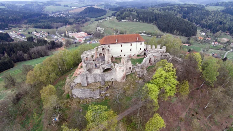 Letecký pohled na hrad Pecka s obnoveným Harantovským palácem a zříceninami nad městysem Pecka v Podkrkonoší