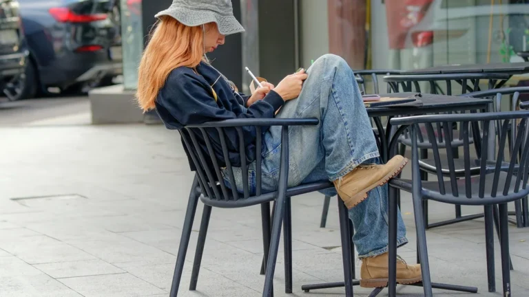 Žena sedí na terase kavárny