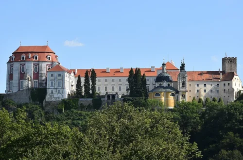 Barokní zámek Vranov nad Dyjí s oválným Sálem předků, kaplí a strážní věží na skále nad zalesněným údolím Dyje